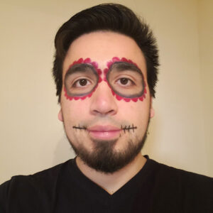 Photo of Christopher with Calavera face paint for Dia de los Muertos